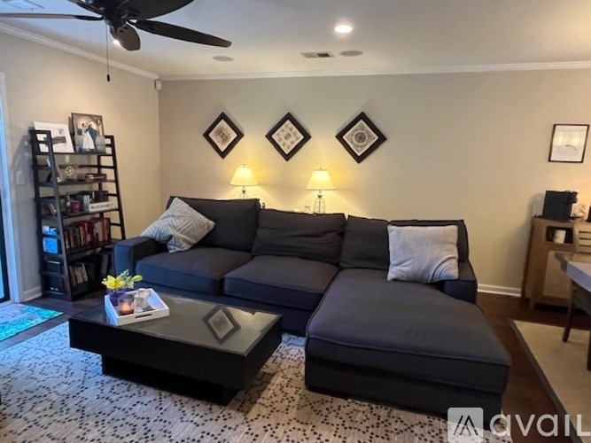 A living room with a grey couch and a coffee table.