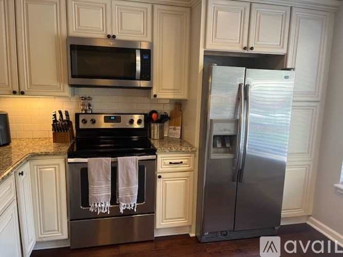 A kitchen with a stainless steel refrigerator and oven.