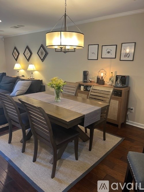 A dining room with a wooden table and chairs.