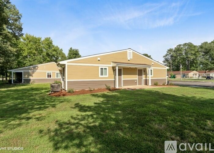 A house with a well-maintained lawn is for sale.