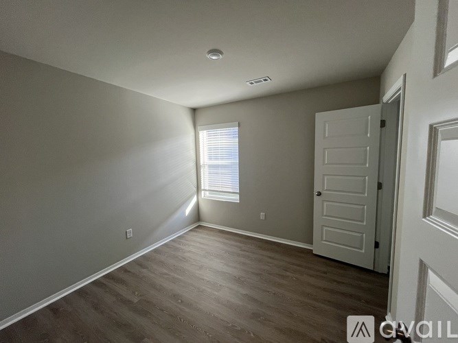 A room with a door and a window.