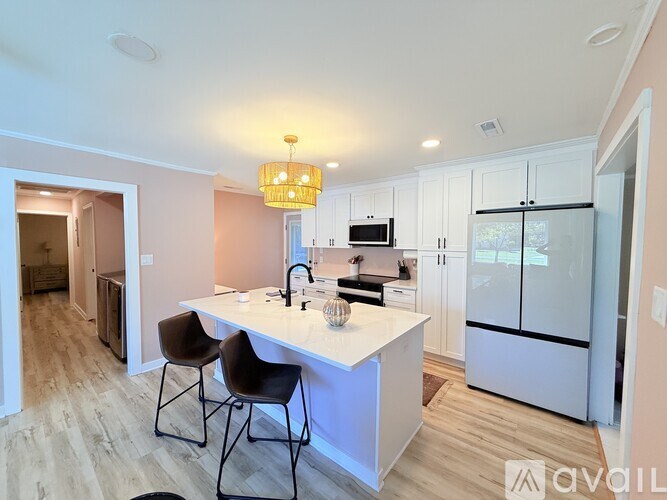 A kitchen with a white countertop and a refrigerator.
