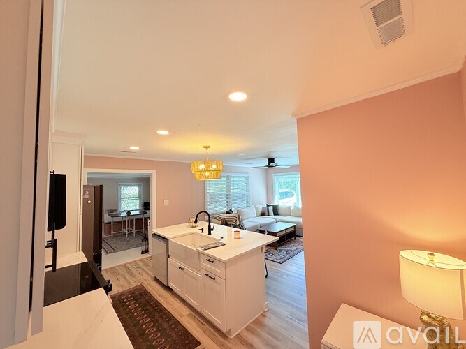 A kitchen with white cabinets and a sink is shown.
