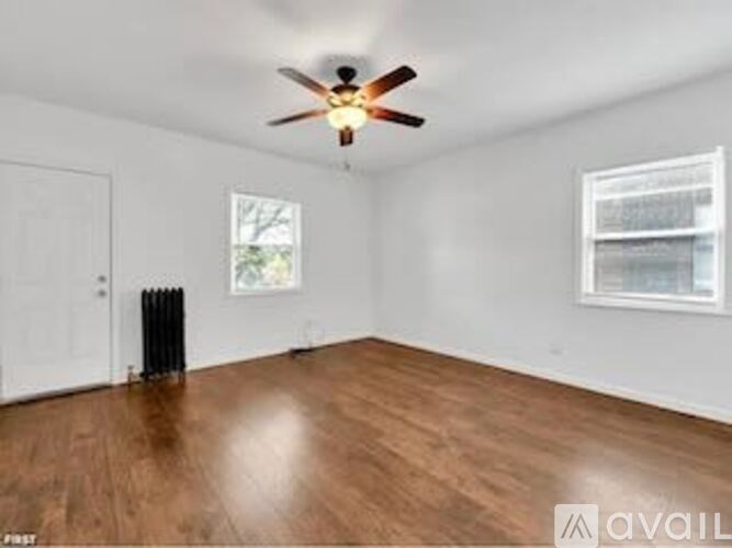 A room with a ceiling fan and a window.