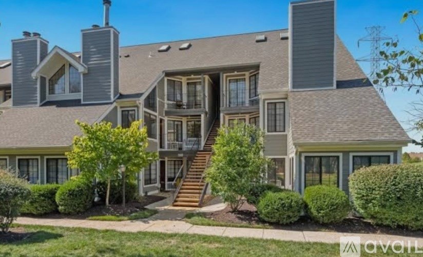 A large house with a staircase leading to the front door.