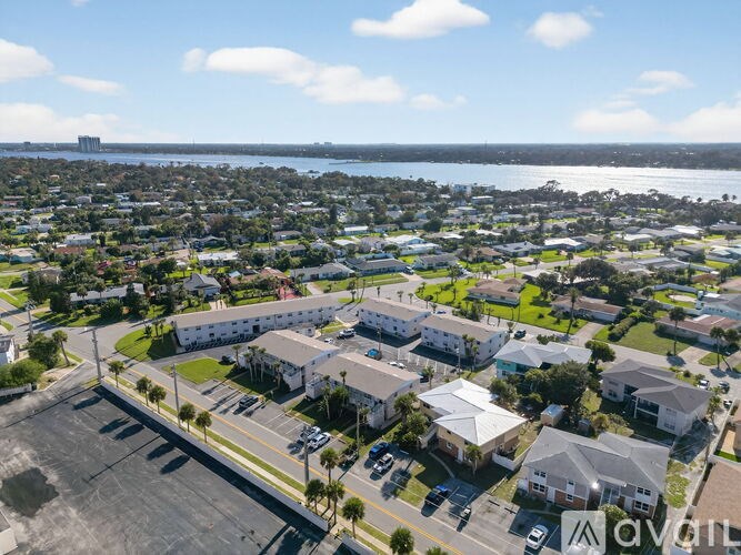 A view of a residential area with houses and a parking lot.