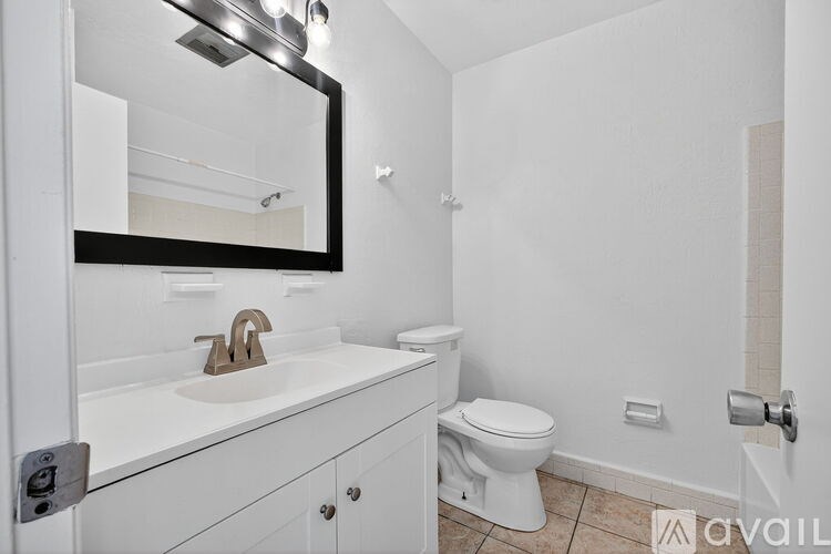 A bathroom with a white toilet and sink.