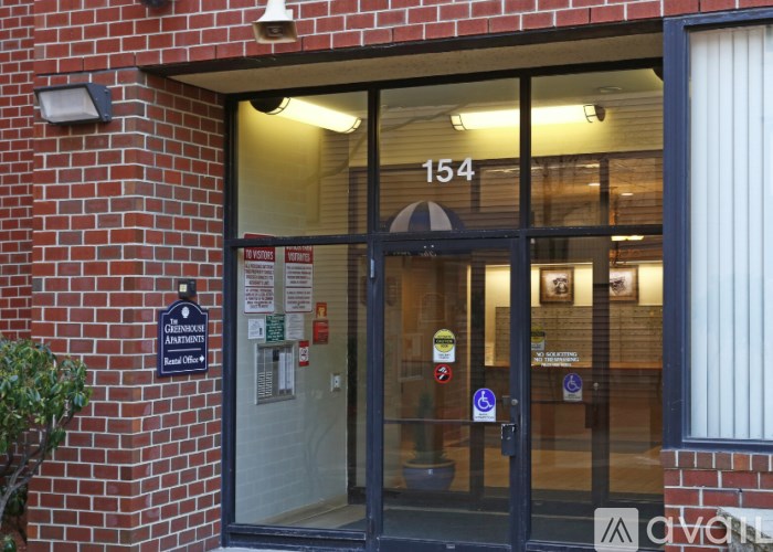 The entrance to a building with a glass door and a sign that reads "154".
