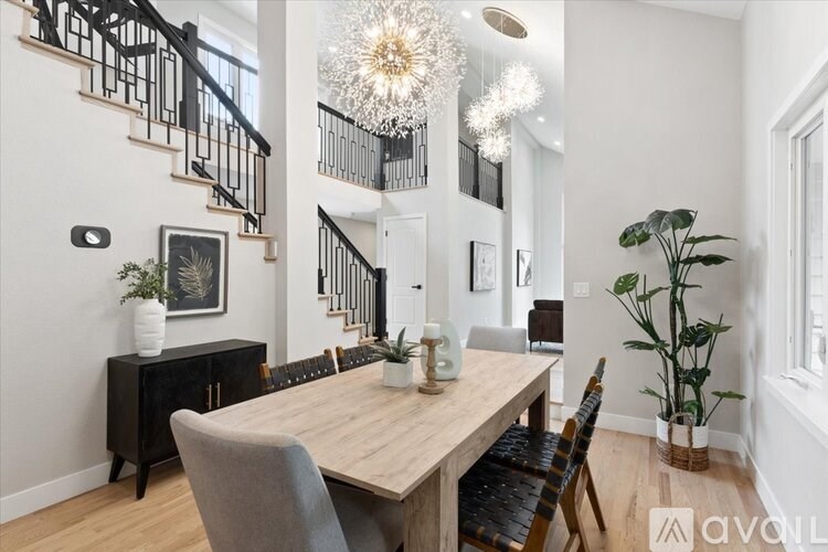 A dining room with a wooden table and chairs.