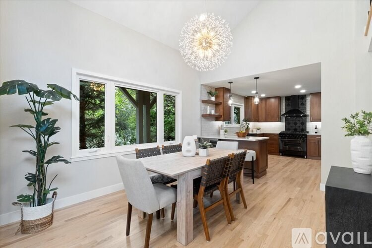 A modern kitchen with a dining table and chairs.