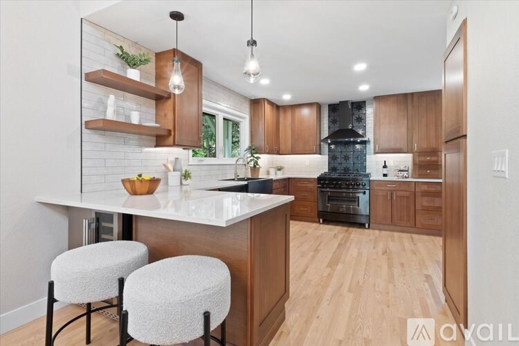 A modern kitchen with wooden cabinets and a white countertop.