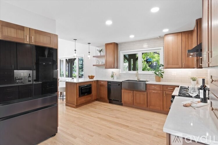 A modern kitchen with wooden cabinets and stainless steel appliances.