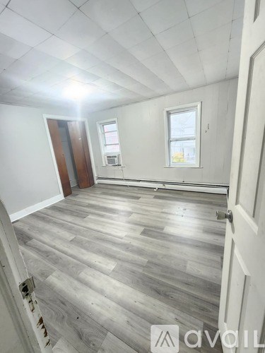 A room with a wooden floor and white walls.