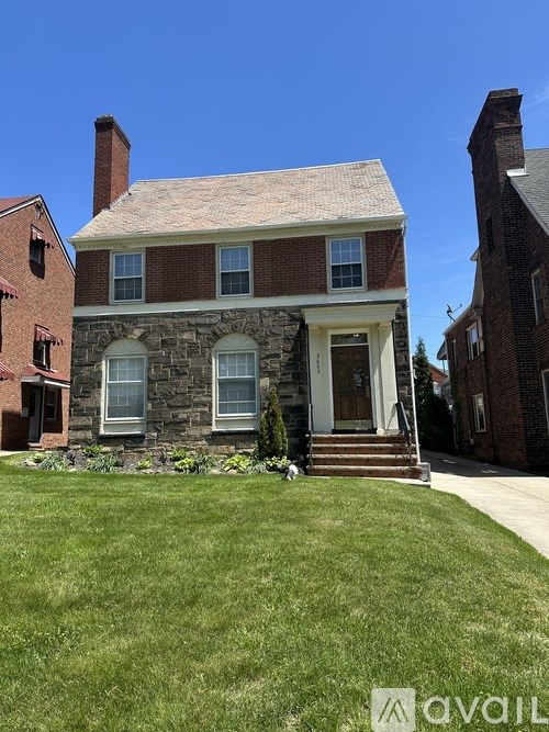 A house with a red brick exterior and a white door.