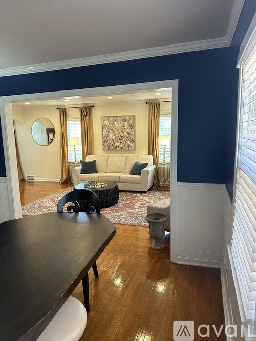 A living room with a white couch and a wooden table.