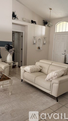 A living room with a white couch and a coffee table.
