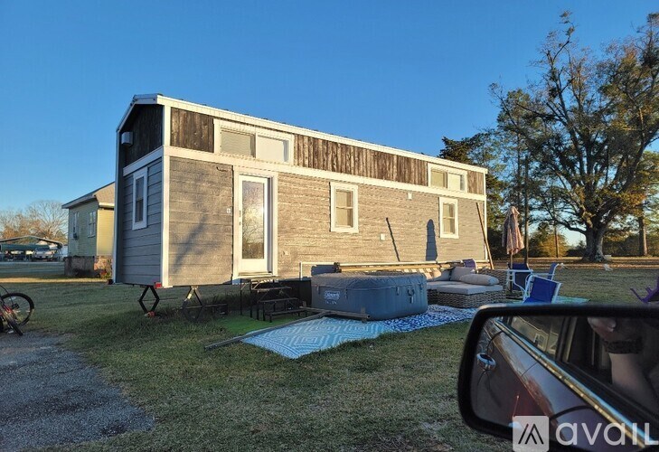 A house with a hot tub in front of it.