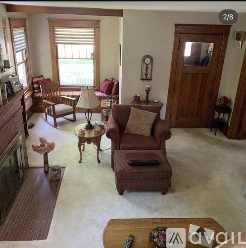 A living room with a brown couch and a wooden coffee table.