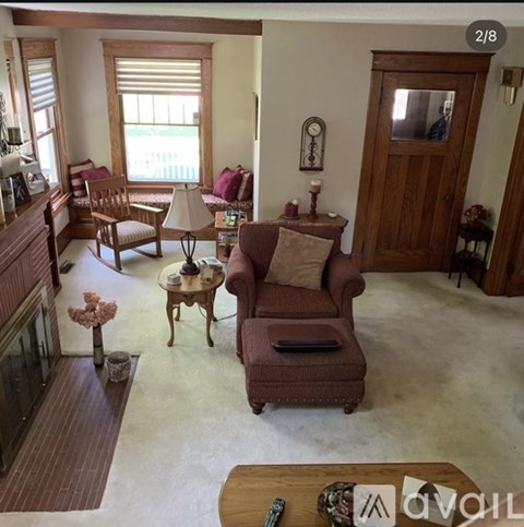 A living room with a brown couch and a wooden coffee table.