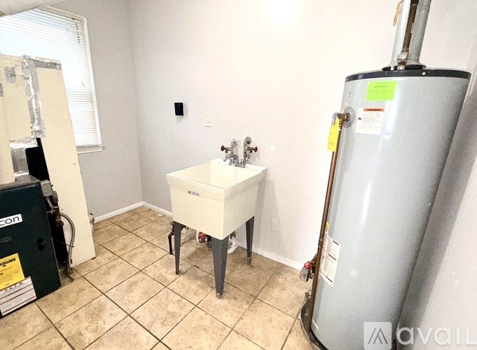 A room with a tank, a table and a cabinet.