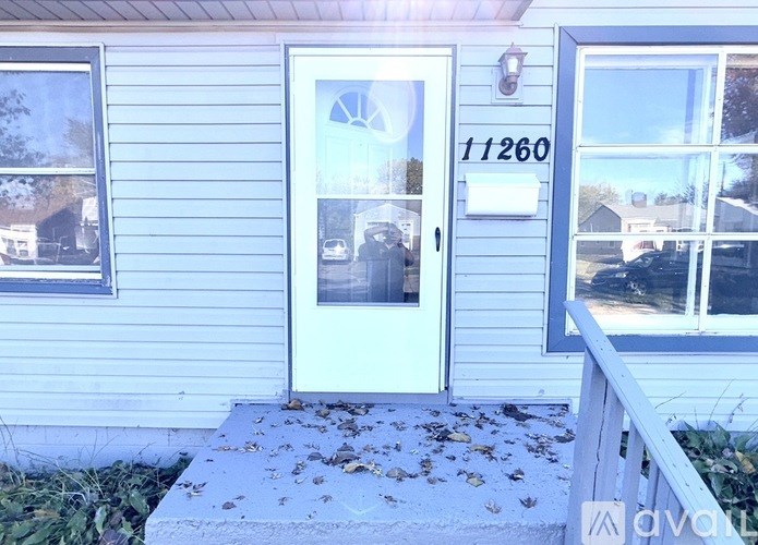 A house with a white door and a number 11260 on it.