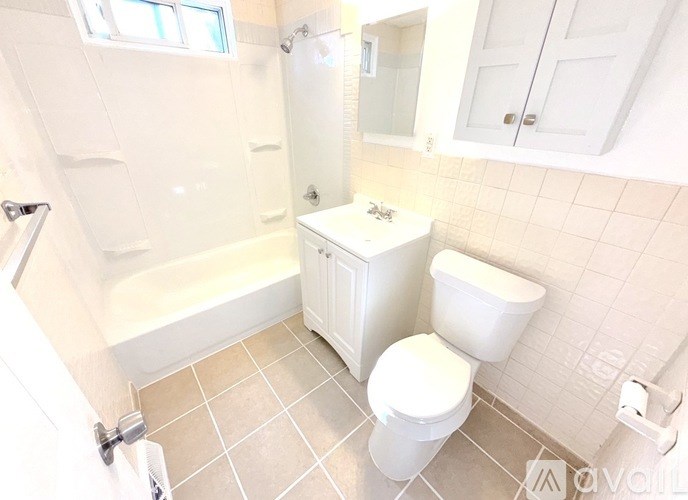 A white toilet and sink in a bathroom.