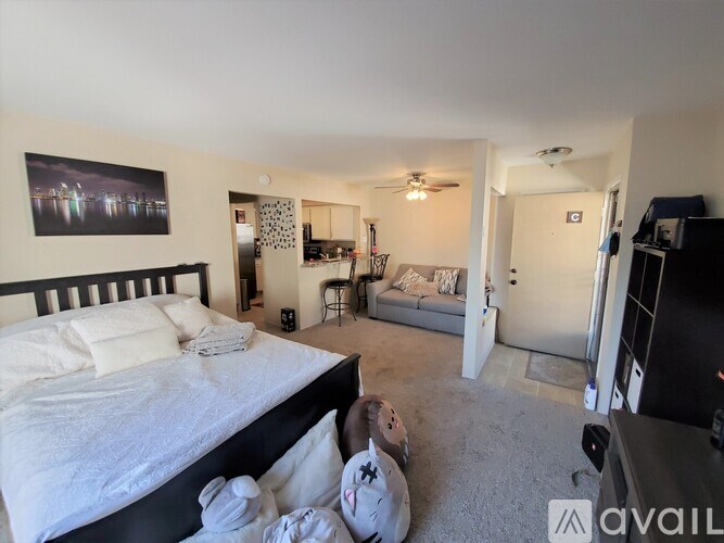 A bedroom with a large bed and a television in the corner.