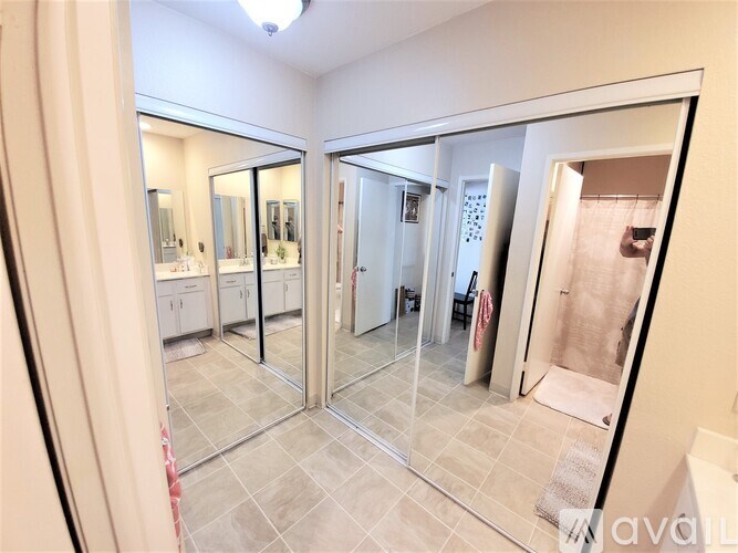 A bathroom with a glass door and a mirror.