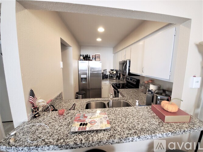 A kitchen with granite countertops and a book on it.