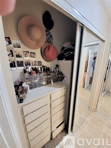 A room with a vanity and a mirror.