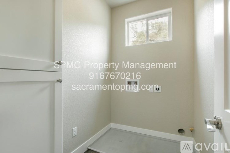 A room with a door, window, and a wall with a hole in it.