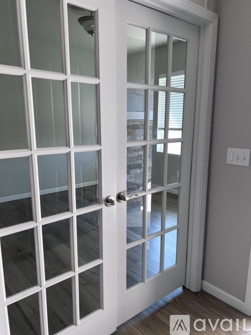 A white door with glass panels and a silver handle.