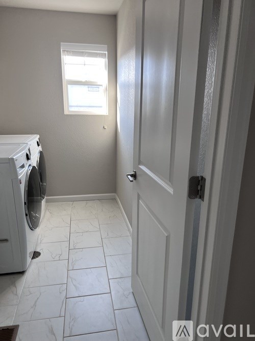 A small laundry room with a washer and dryer.