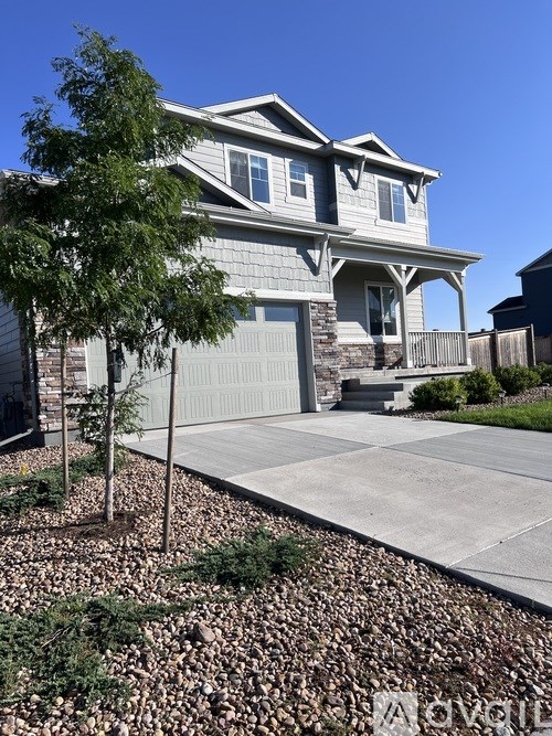 A house with a grey roof and a grey garage door.