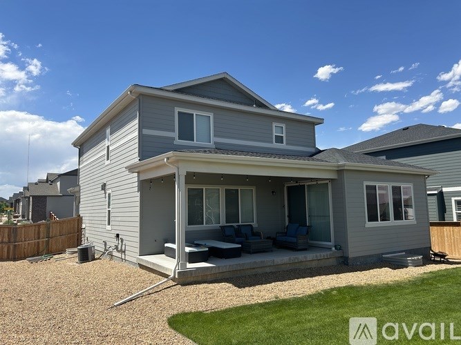A house with a grey exterior and a covered patio area.