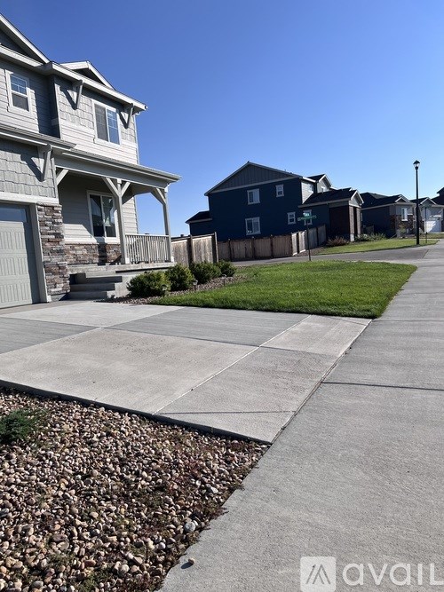 A row of houses with a sidewalk in front.