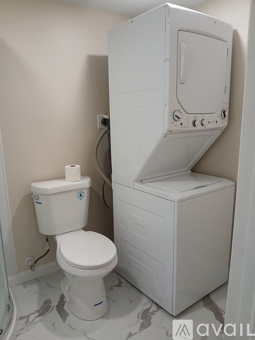 A white toilet and sink in a bathroom.