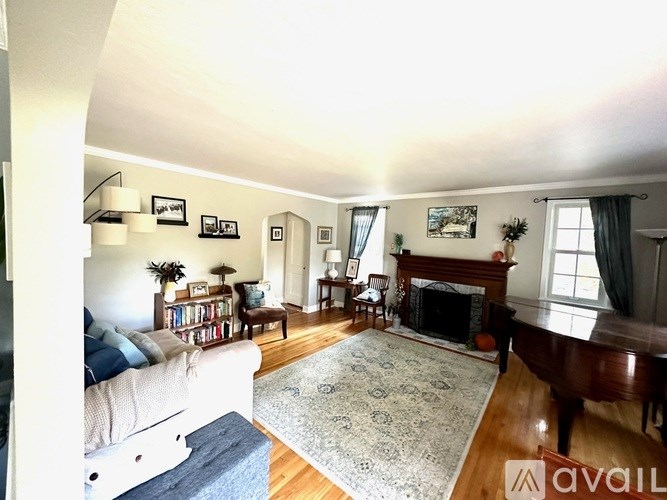 A living room with a fireplace and a piano.