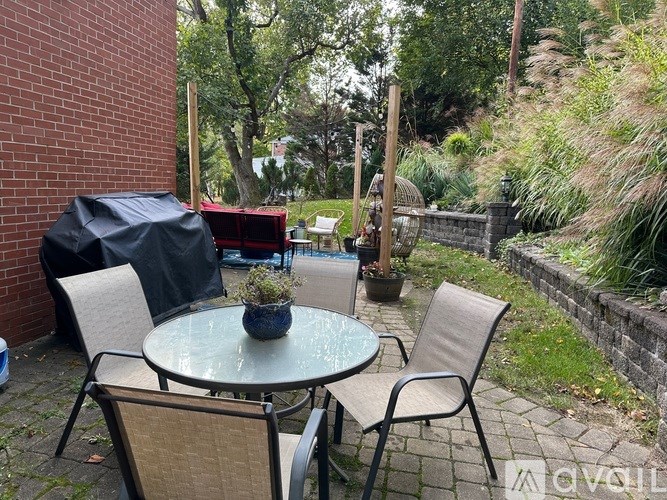 A patio with a glass table and chairs.