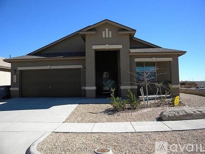 A two-story house with a garage and a driveway.