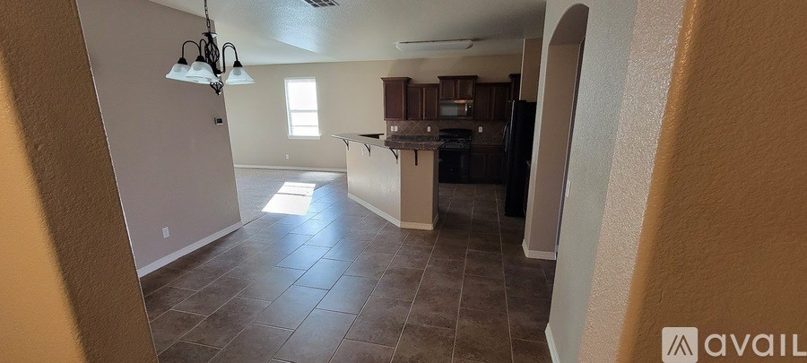 A kitchen area with a counter and a refrigerator.