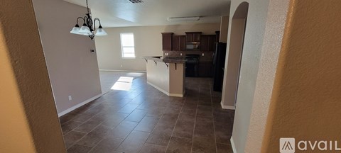 A kitchen area with a counter and a refrigerator.