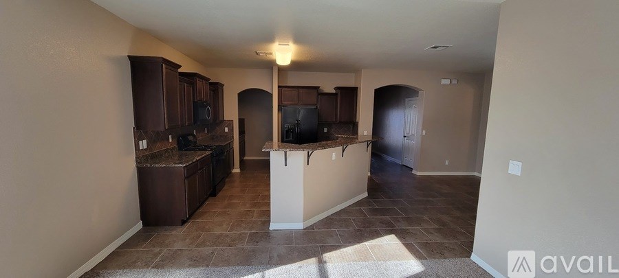 A kitchen with brown cabinets and a countertop.