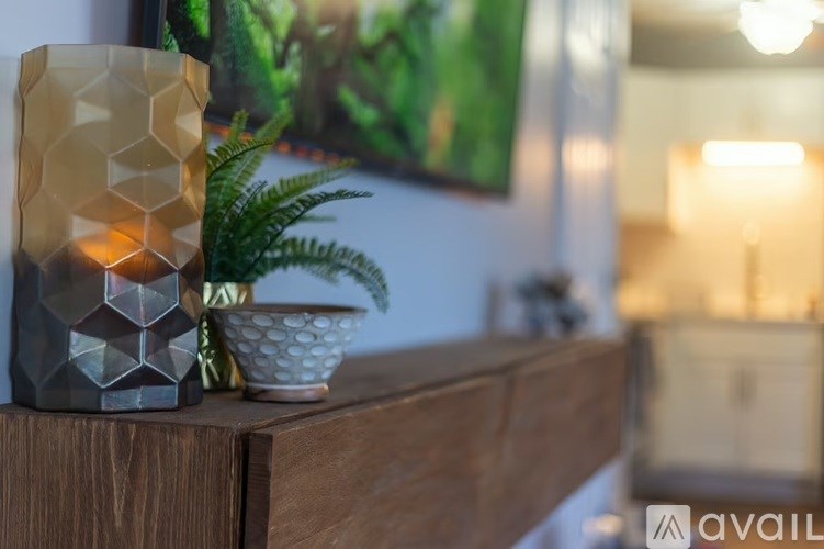 A modern table lamp with a geometric design is placed on a wooden surface.