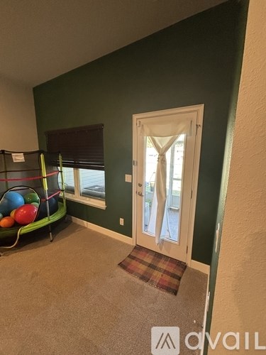 A room with green walls and a white door.