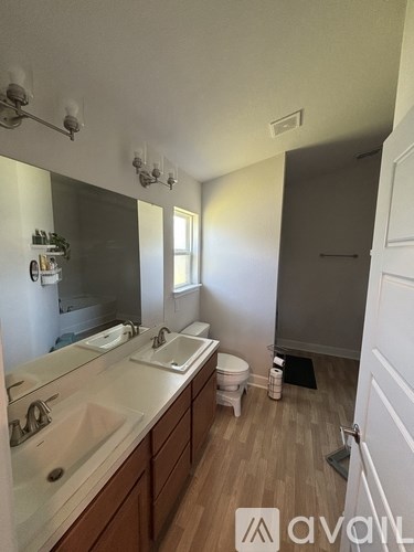 A bathroom with a white sink and a white toilet.