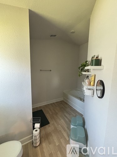 A bathroom with a toilet, a sink, and a mirror.