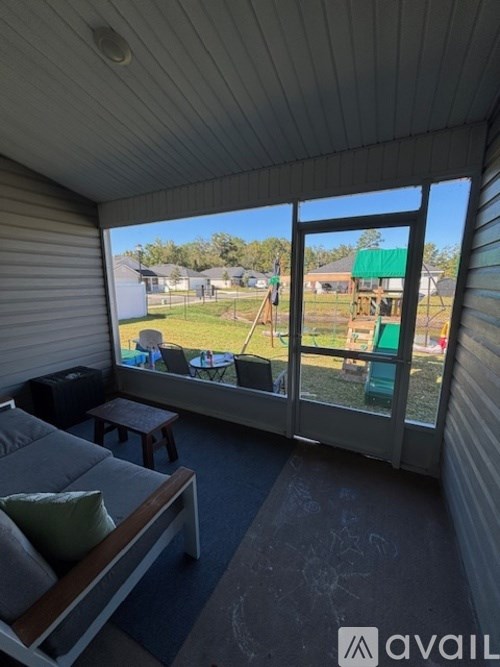 A sunny patio with a couch and a table.