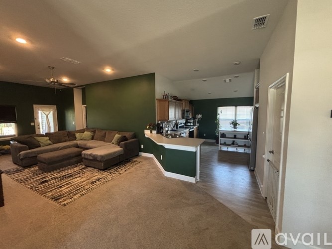 A living room with a couch and a rug.