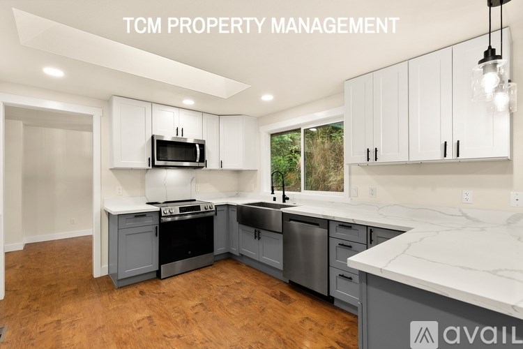 A kitchen with a microwave on the counter.